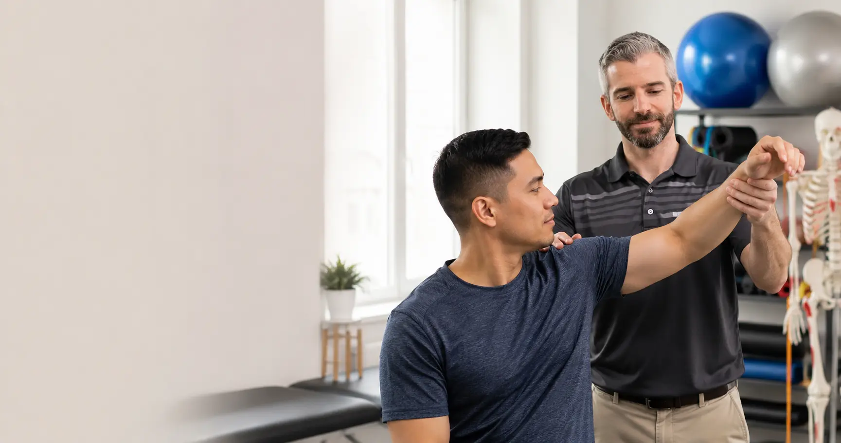 Physiotherapist assessing shoulder pain in a patient at Motion Plus Physiotherapy in Guelph